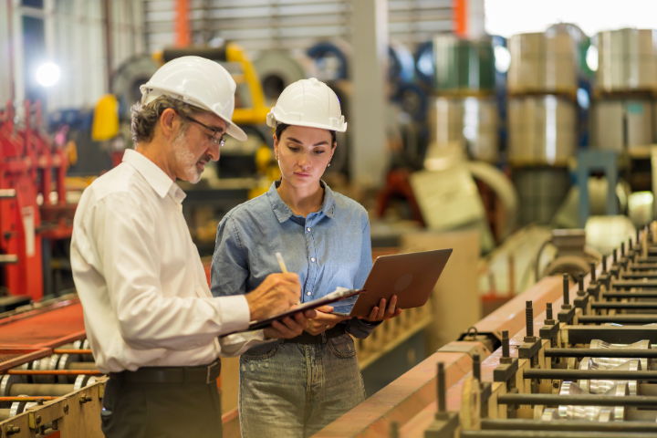 Manufacturing managers discussing key variables in their financial health check objectives.