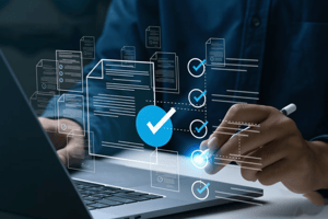 Person using a laptop with a glowing digital interface of document icons and blue checkmarks.