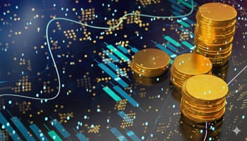 Stacks of gold coins overlay a dark, digital background featuring glowing candlestick charts and a smooth, white trend line, symbolizing financial data and investment growth.