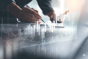 Close-up of a hand signing a document overlaid with glowing financial data charts.