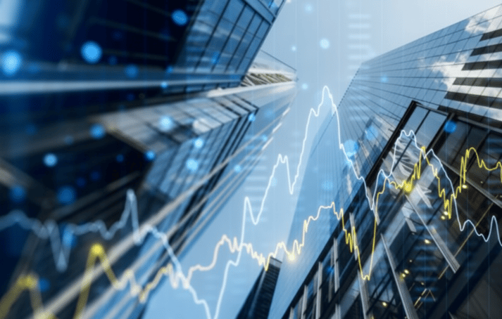  A low-angle view of modern skyscrapers with a glowing financial graph overlaid on the image.