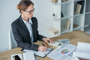 woman computing to see if her goals are in financial alignment with her supply chain operations business