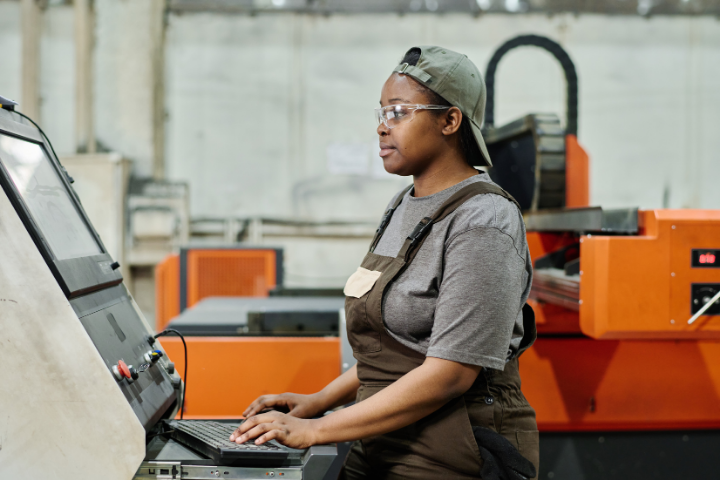 Woman using new equipment paid for by manufacturing budget