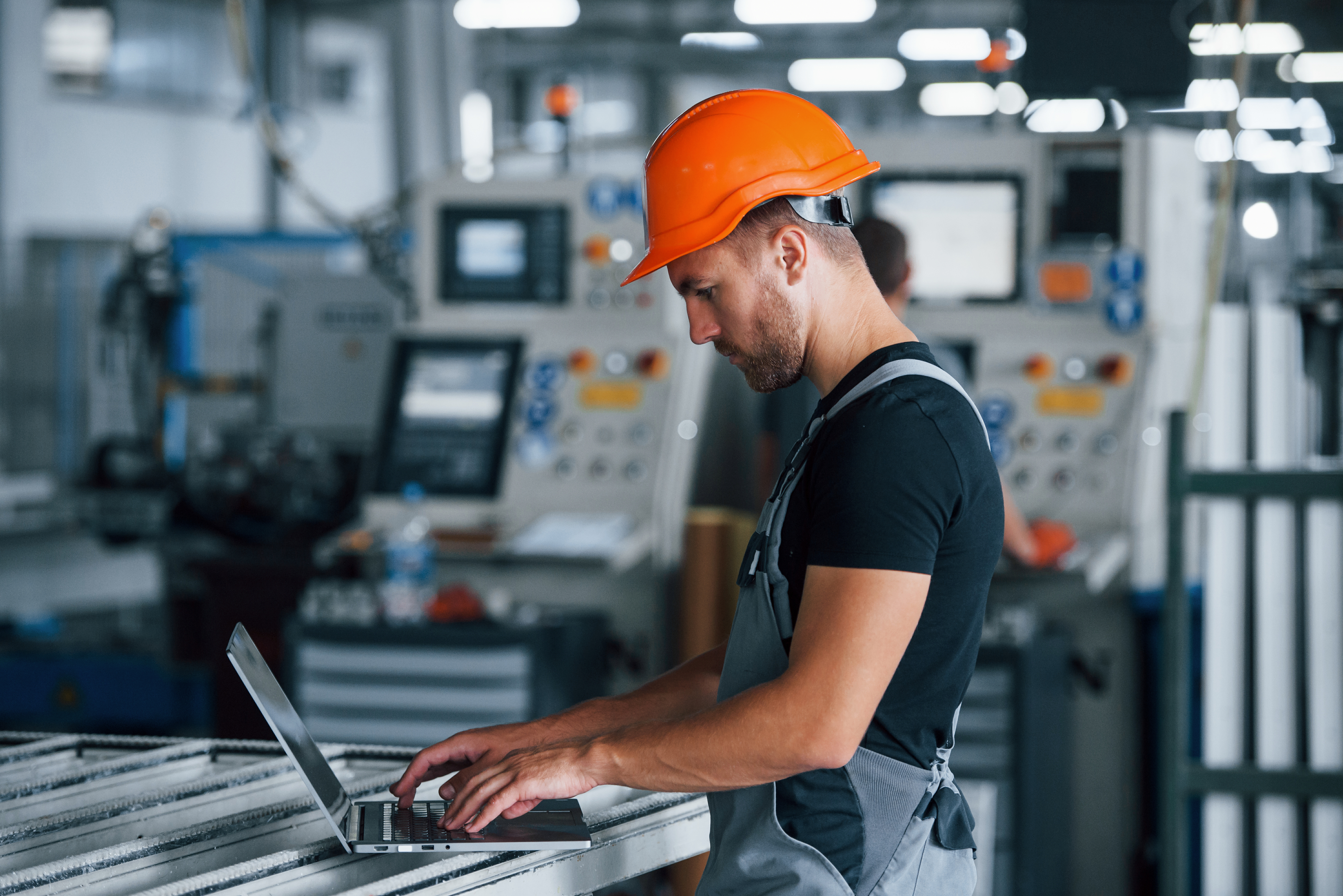 man reviewing the plan for maximizing profitability of manufacturing facility