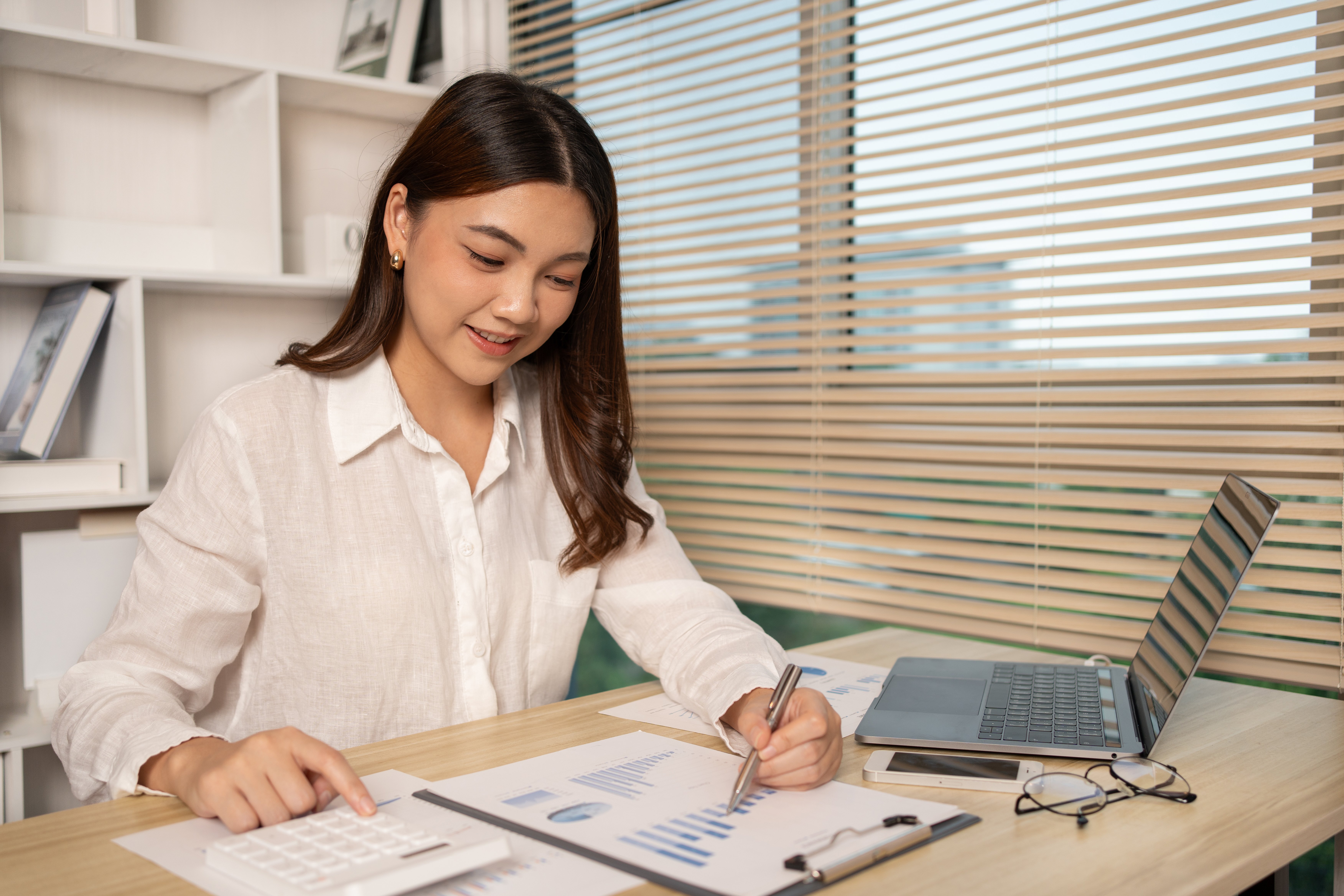 A woman performing outsourced bookkeeping responsibilities