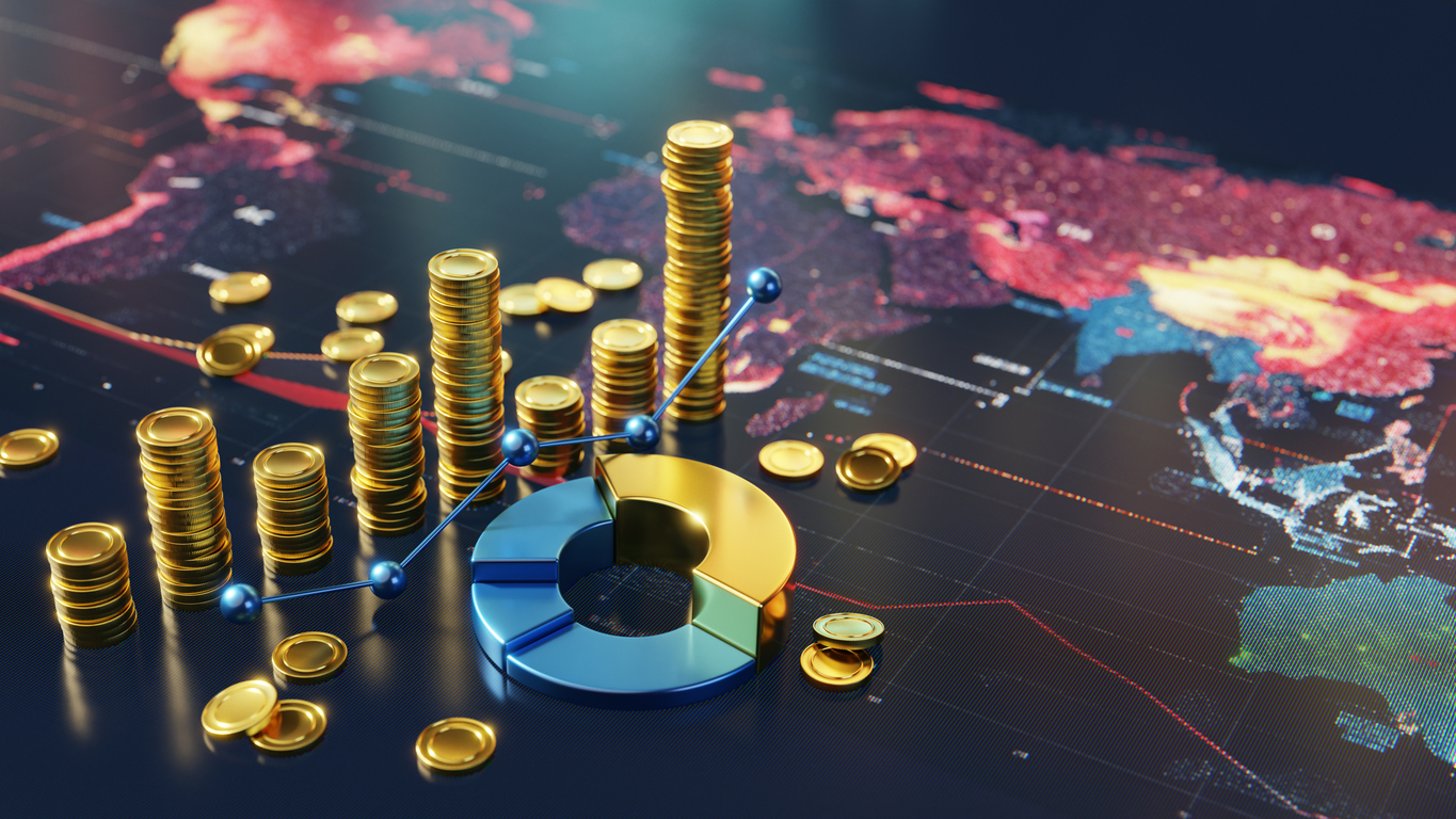 Two workers in hard hats examine a tablet in a warehouse.